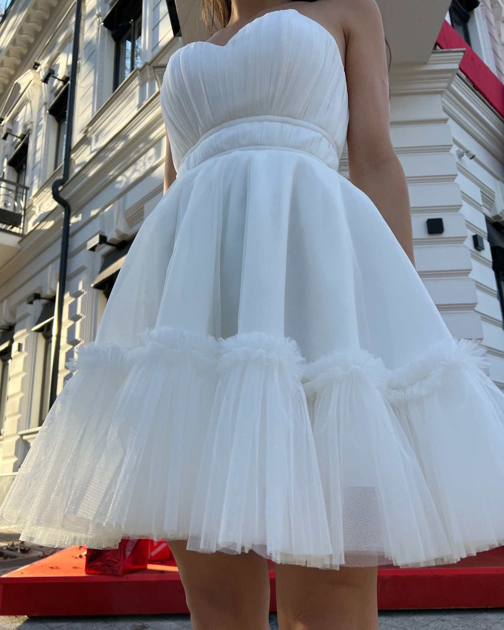 Rochie de ocazie albă scurtă cu corset și fustă evazată.