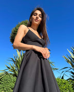 Rochie neagra elegantă scurtă cu bretele, fustă evazată, decolteu, fermoar la spate.