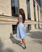 Rochie albastră midi elegantă cu decolteu semitransparent și croială rafinată, ideală pentru evenimente speciale.