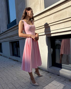 Rochie roz eleganta roz midi cu decolteu și sistem de închidere laterală.