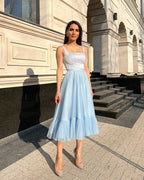 Rochie eleganta petrecere albastră midi evazată din satin regal fără mâneci.